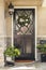 Black front door to home with flower wreath