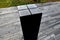 Black gabbro stone prism. it stands in the park and is bevelled and polished. if it gets wet, you can play various sound melodies