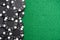 Black gambling chips on green felt background with