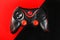Black gamepad on a black red background, . Gaming concept