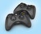 Black gamepads multiplayer games illustration on blue gradient background 3d