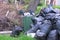 Black garbage bags near and an overturned trash can on the street.