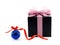 black gift box with glittering pastel pink ribbon net bow and glossy blue christmas ball with red ribbon