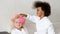 Black girl hangs hair curlers to her friend