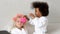 Black girl hangs hair curlers to her friend