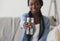 Black Girl Holding Glass of Mineral Water Offering it On Camera