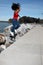 Black girl jumping by lake