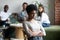 Black girl outcast sitting apart from peers in cafeteria