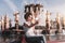 Black girl is photographing herself in front of a fountain