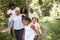 Black girl walks with grandma and family in forest, close up