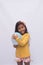 Black girl in yellow shirt playing, photo with white background. child playing with balloon isolated