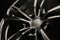 Black Gloss alloy wheel on a dark background. Stylish and expensive. Close-up of spoke elements
