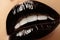 Black glossy lips makeup. Macro beauty shot of face part. Halloween look with black lipstick