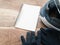 Black gloves motorcycle and white helmet and white book on wood