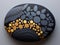 A black and gold painted rock sitting on top of a table