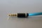 Black and golden jack plug with blue cable