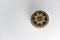 Black and golden ornamented button with floral mandala pattern on the front side. Selective focus