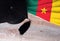 Black graduation hat on Cameroon flag, education concept, top view