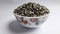 black grams in bowl   on white background