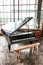 Black Grand Piano and stool in a well lit room