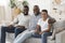 Black Grandfather With Son And Grandson Relaxing Together At Home