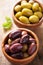 Black and green marinated olives in bowl