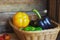 Black, green and yellow paprika`s in a wicker basket.