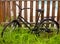 Black grunge bicycle aged on a wood fence