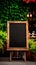 Black grunge menu frame board stand near outdoor cafe or restaurant. Blank store signage sign design mockup. Signboard