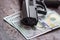 Black gun on American dollars background. Military industry, war, global arms trade, weapon sale, contract killing and crime