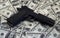 Black gun pistol and money dollars background