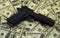 Black gun pistol and money dollars background filtered