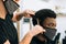 Black guy in a hair salon with a coronavirus mask