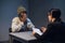 A black guy listens to his rights from a civil lawyer at a table in a visiting room in a state prison