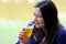 Black hair latin woman drinking beer outdoors taking selfie with view of san miguel de allende parish in guanajoato mexico