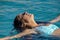 Black hair mexican latina girl swimming in crystal sea waters