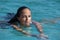 Black hair mexican latina girl swimming in crystal sea waters