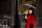 Black hair women on cemetery with umbrella