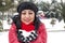 Black haired Turkish women holding a red heart in her hand and celebrating Valentine\'s day with snowy background