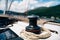 Black halyard winch with a variegated cable against the backdrop of a mountain landscape