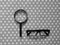 Black Hand-Held Reading Magnifier, Magnifying Glass, a Pair of Glasses on grey and white spotted pattern background.