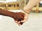 Black hand and white hand, adoption mother, interracial concept
