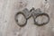 The black handcuffs on wooden background. criminal justice