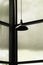 Black hanging metal lamp with glass wall interior room dark background
