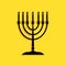 Black Hanukkah menorah icon isolated on yellow background. Religion icon. Hanukkah traditional symbol. Holiday religion