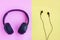 Black Headphone and Black wired earphones on pink and yellow background