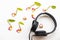 Black headphone of listening with petal flowers frangipani arrangement music score flat lay style