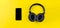 Black headphones and mobile phone on a yellow background. Concept of musical streaming