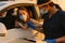 Black health worker wearing protective visors working with woman