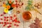 Black herbal tea in a transparent cup on a wooden table. Autumn